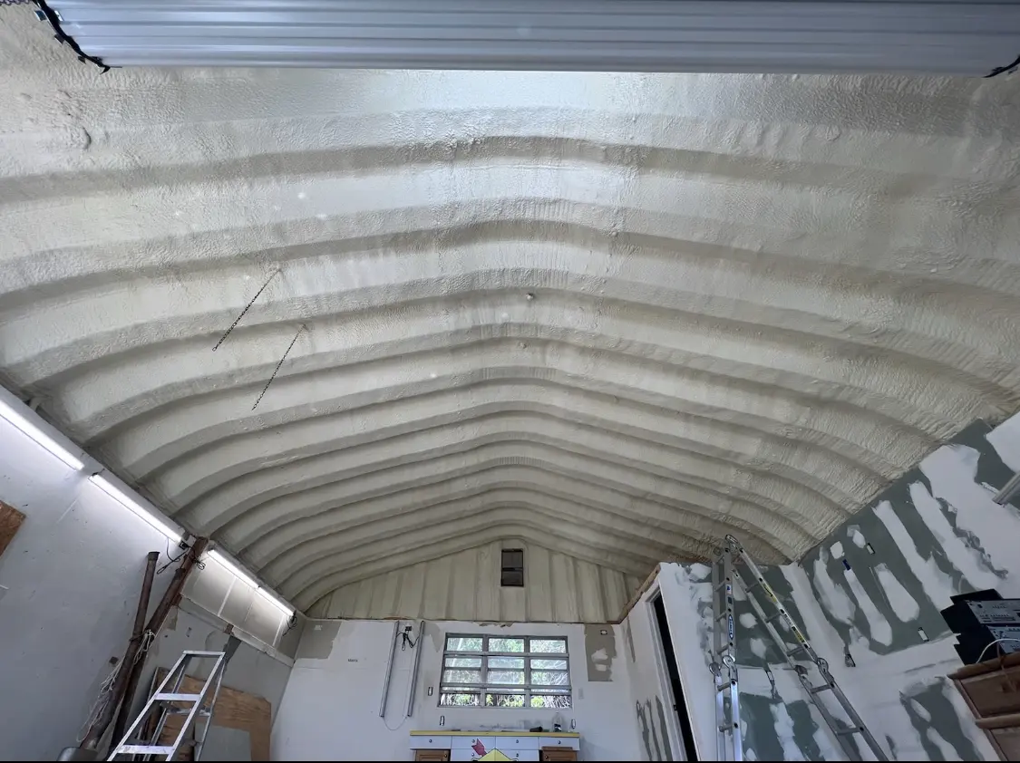 Spray polyurethane foam applied to the underside of a metal roof deck in Providence Village